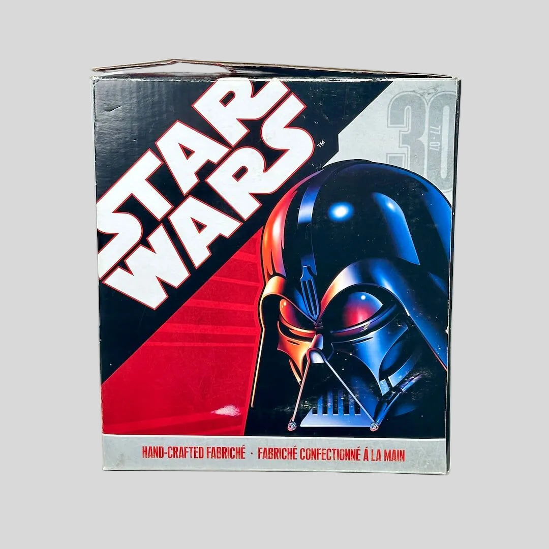 Collectible action figure box featuring Darth Vader on a white background.