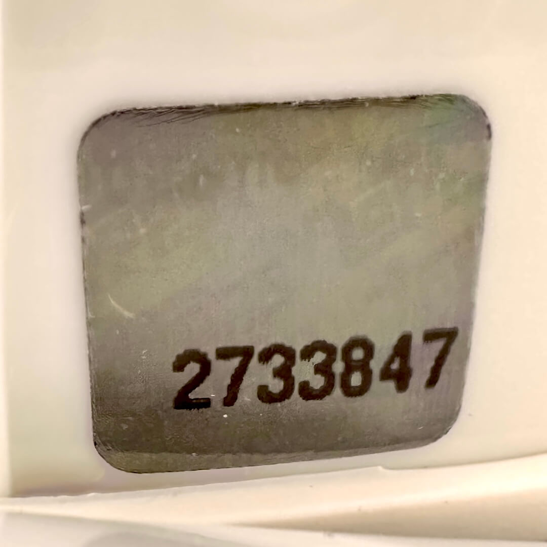 Close-up of authentication sticker with visible number.