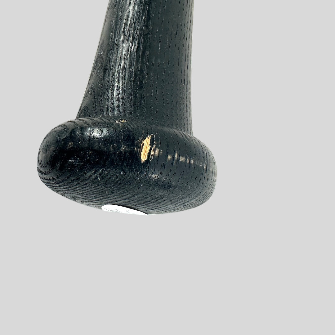 Close-up of a black wooden handle on a white background
