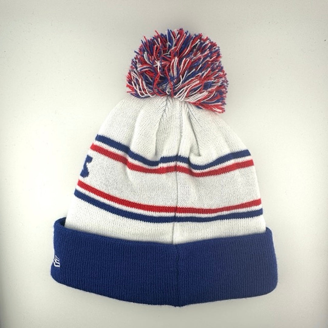 White knit cap with red/blue stripes around blue team name, blue cuff with Bills logo front center & blue/white/red pom atop