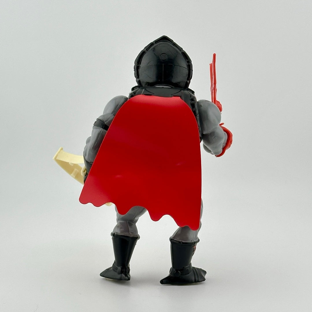 Action figure back with red cape. Holding white crossbow and red bat. Figure has grey arms and legs with black boots.