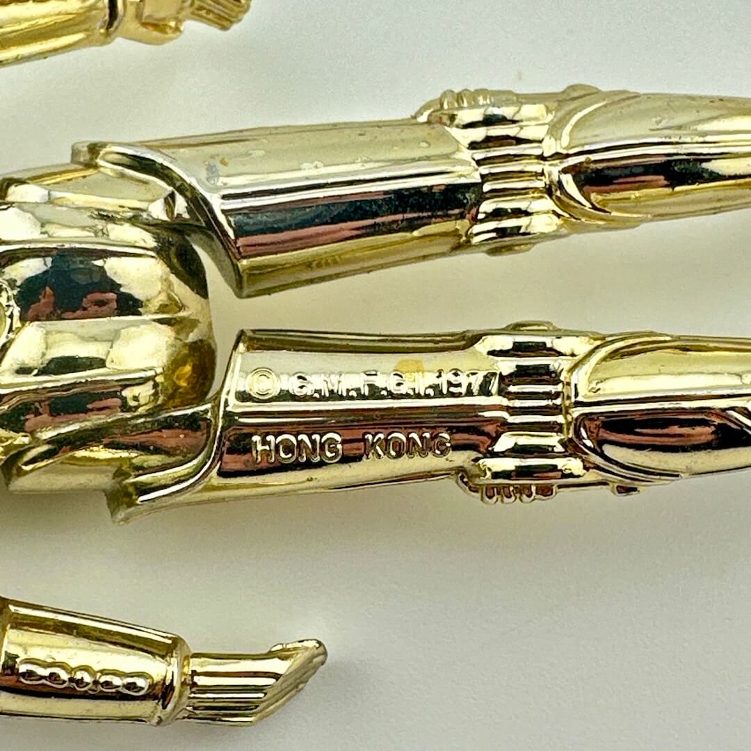 Close-up of back of figure's legs to show COO and copyright information.