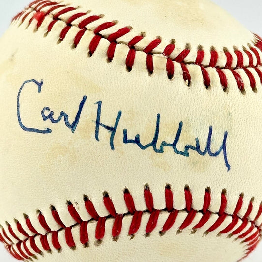 Baseball with red stitching and a blue signature on a white background