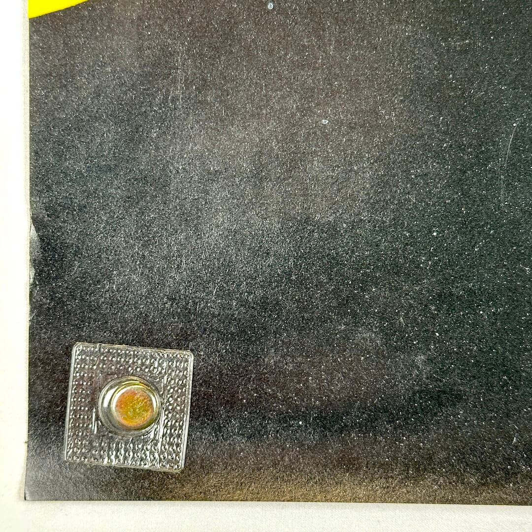 Bottom left corner with small bump to edge.