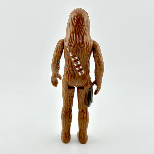 Toy figure of a character with long hair and a satchel on a white background