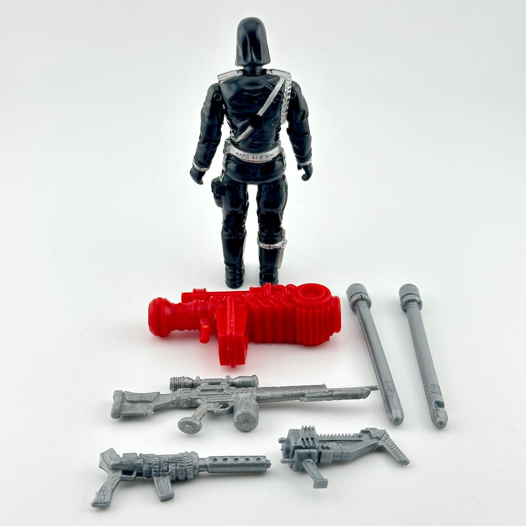 GI Joe Cobra Commander action figure in all black with silver accents, pictured with silver and red accessories.