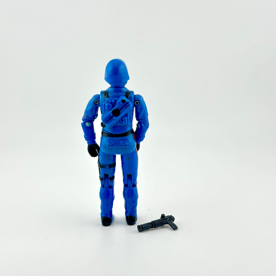Back of GI Joe Cobra Commander action figure with weapon against white background.