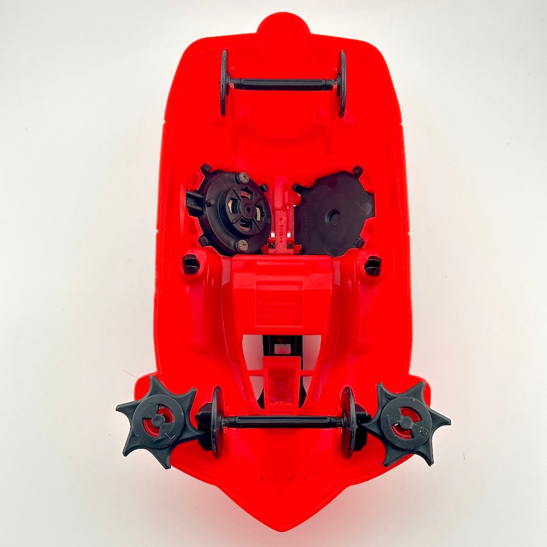 Red and black toy vehicle against white background.