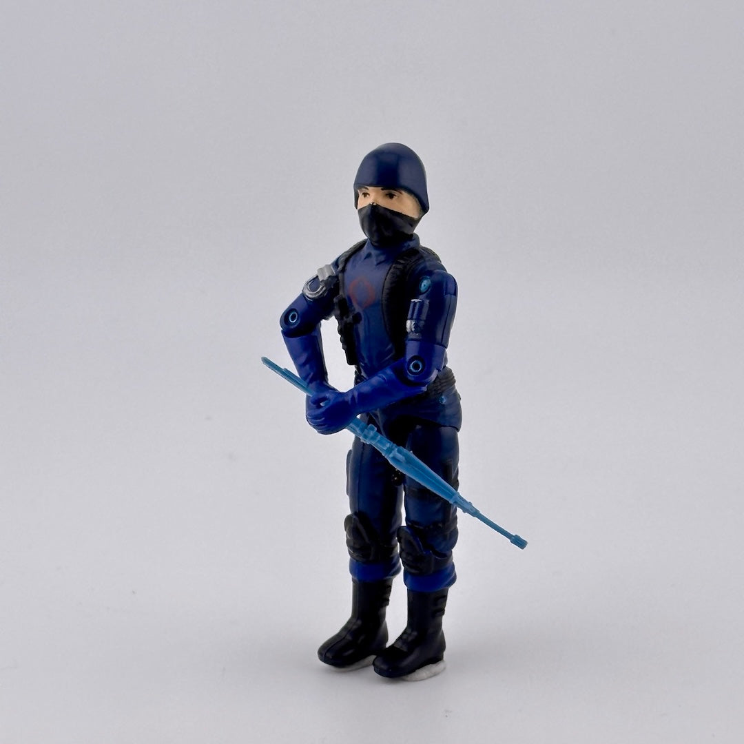 White, male, masked ninja in blue uniform with black details, red COBRA logo on chest. Carrying mini rifle. Front view.