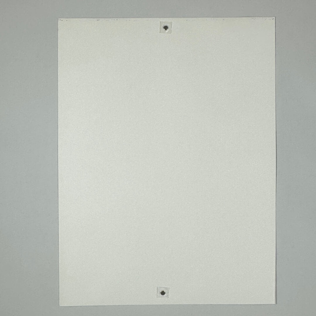 Backside of white poster showing textured paper with some ink transfer from printing.