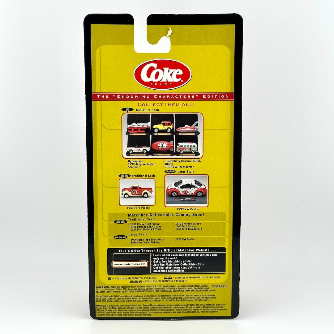 Back of a Coke collectible car package, featuring a bright yellow card with black border, red and white Coke logo.