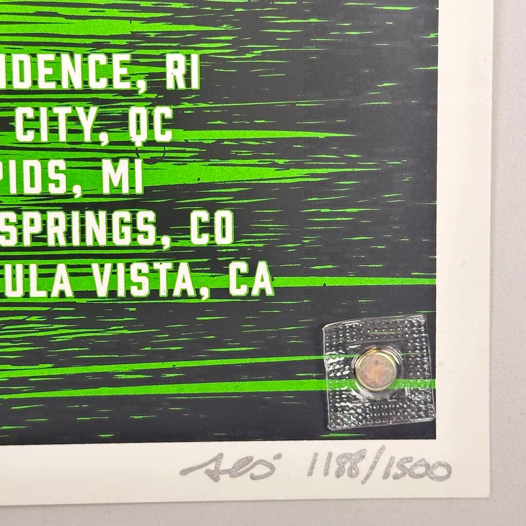 Bottom right corner of poster showing no damage to corner or edges. Artist signature and poster number in silver marker at corner.