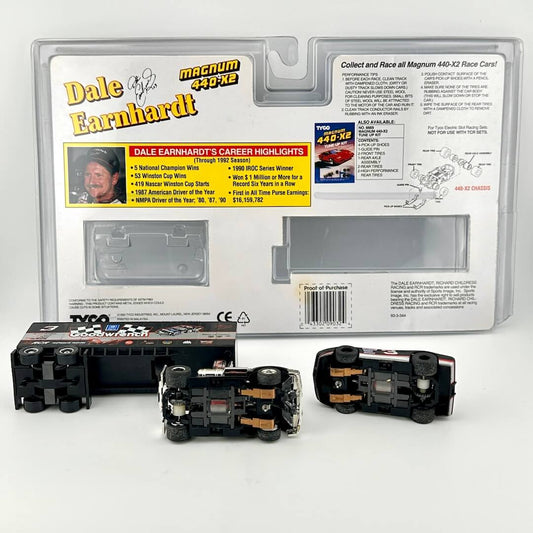 Slot cars with packaging against white background.