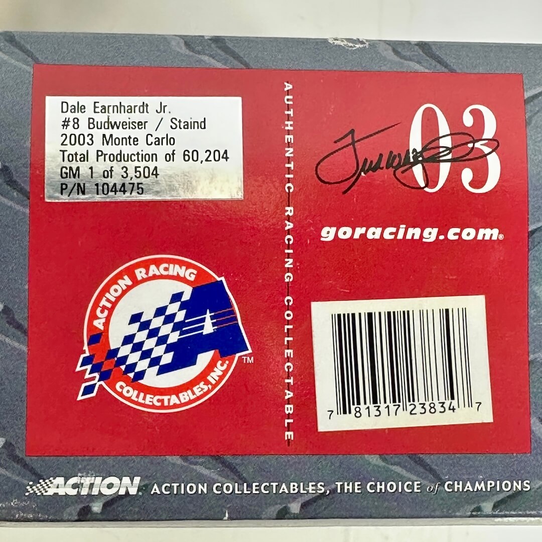 Back of a collectible car model with branding and specifications on a red label.