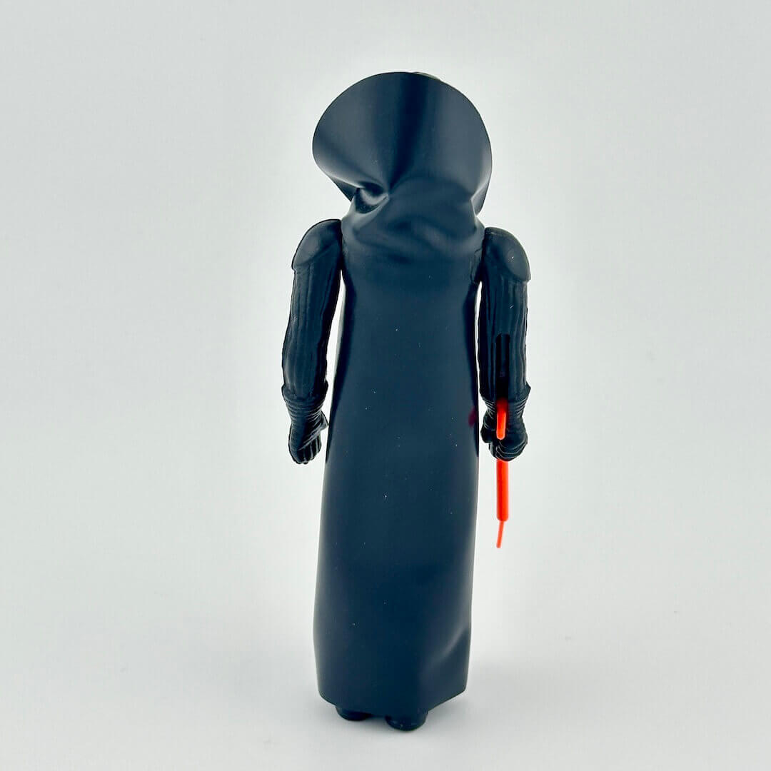 Toy figure of a character in a black robe with a red lightsaber on a white background