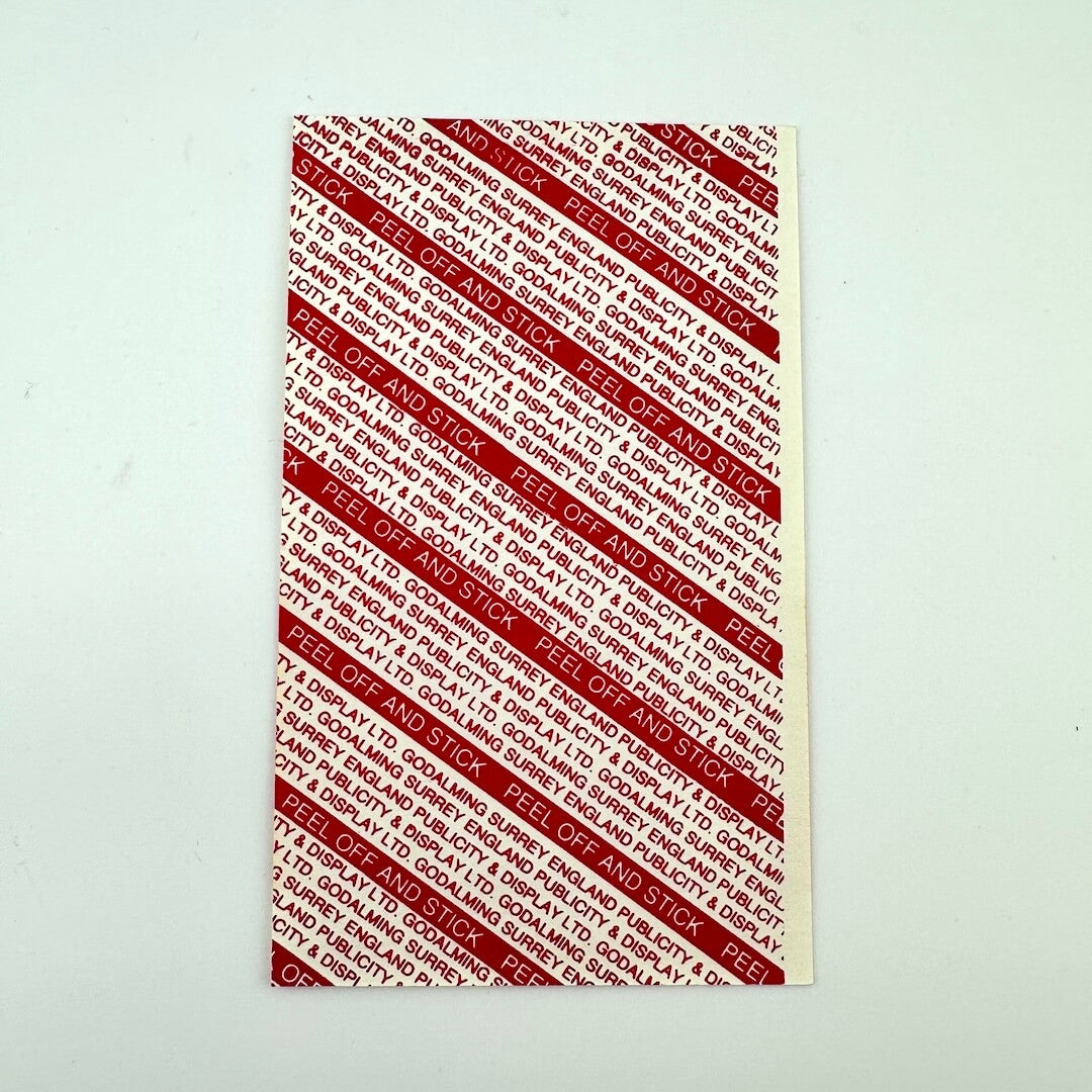 Backside of event pass showing intact backing and pristine condition.