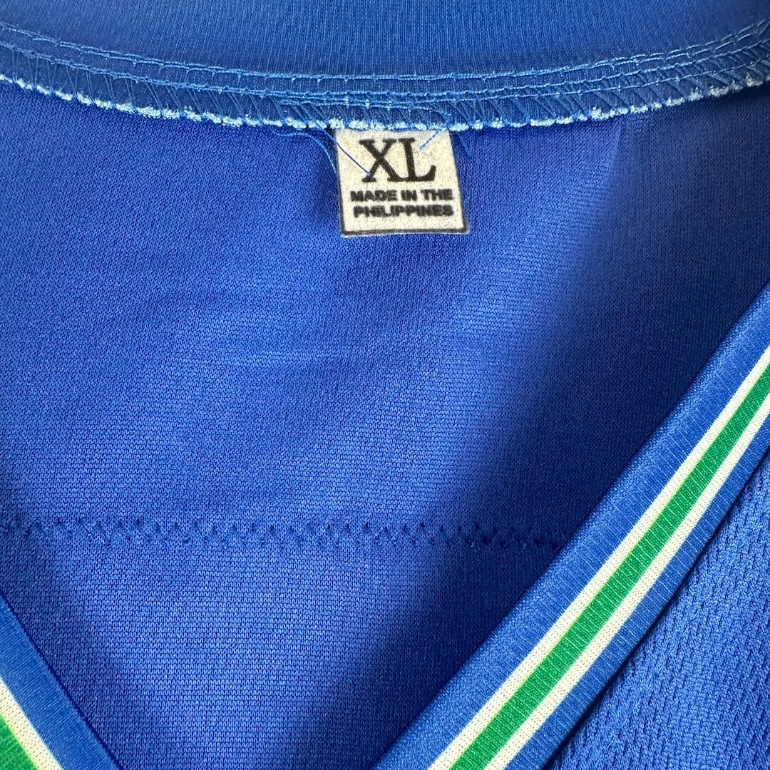 Close-up of a blue garment with a size label indicating XL, made in the Philippines.