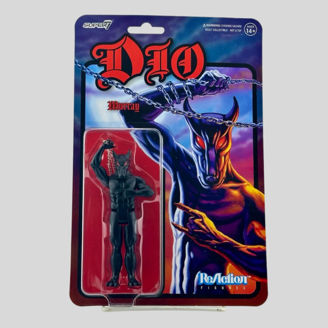 Black demon figure swinging chain in blister & pictured on backing, red name at top, white/blue logos in opposite corners.
