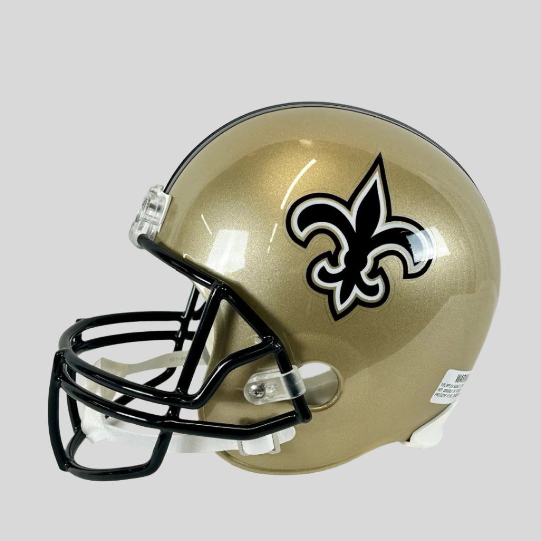 A full-size authentic New Orleans Saints helmet with Drew Brees's signature in black marker on the side.