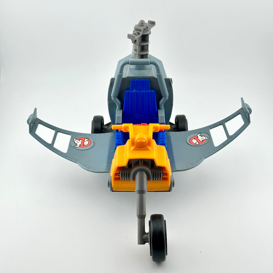 Toy helicopter with gray body, blue rotor blades, and yellow tail rotor on a white background