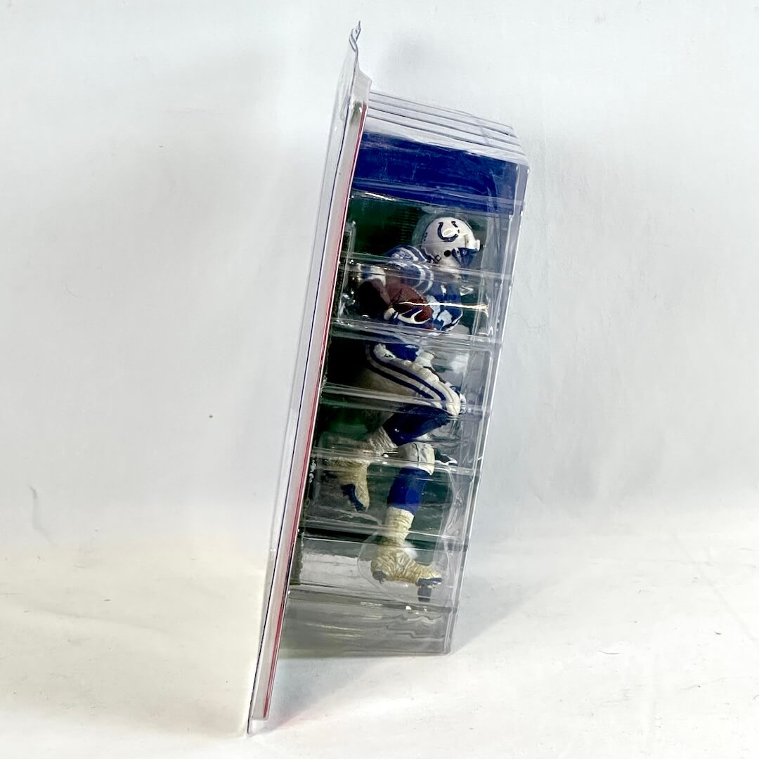 Collection of sports figurines in a clear plastic display case on a white background