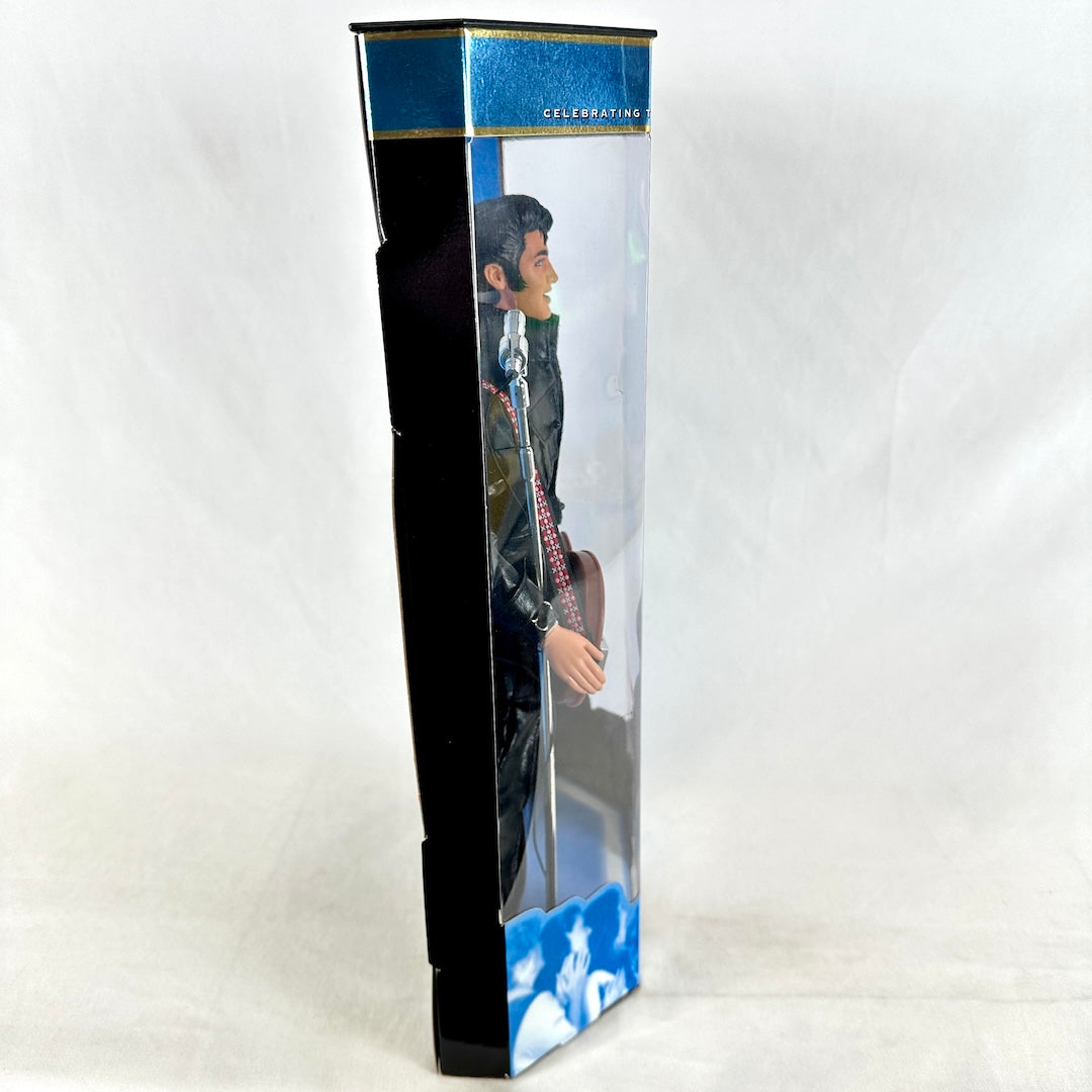Toy figure in a box with a guitar, on a white background
