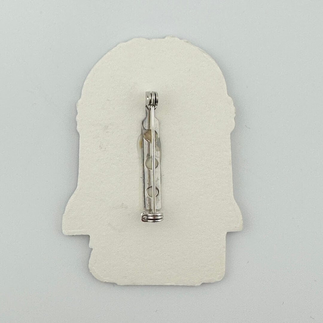 Backside of pin against white background.