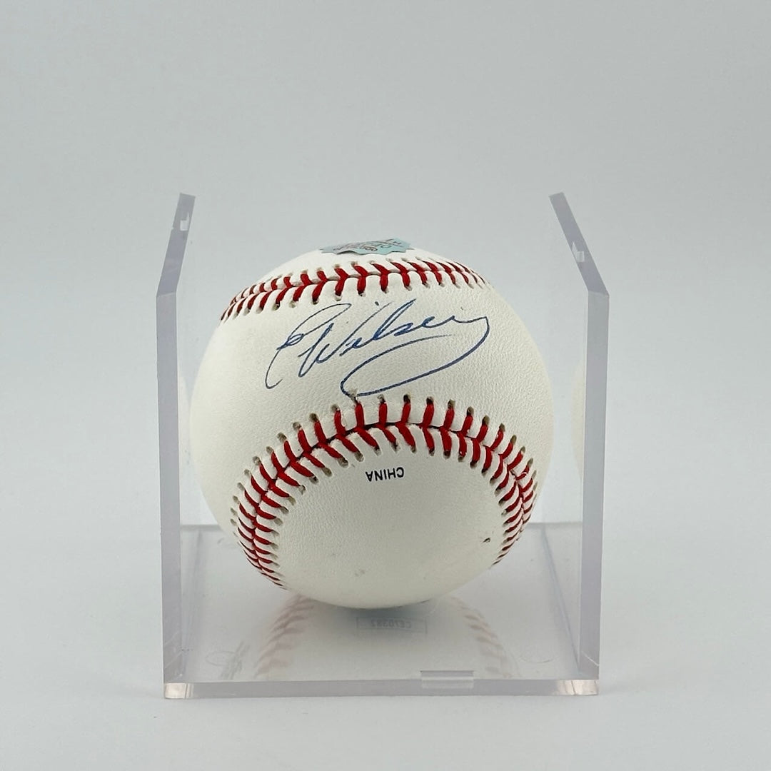 Autographed baseball in plastic cube. Half of cube removed to show clear signature.