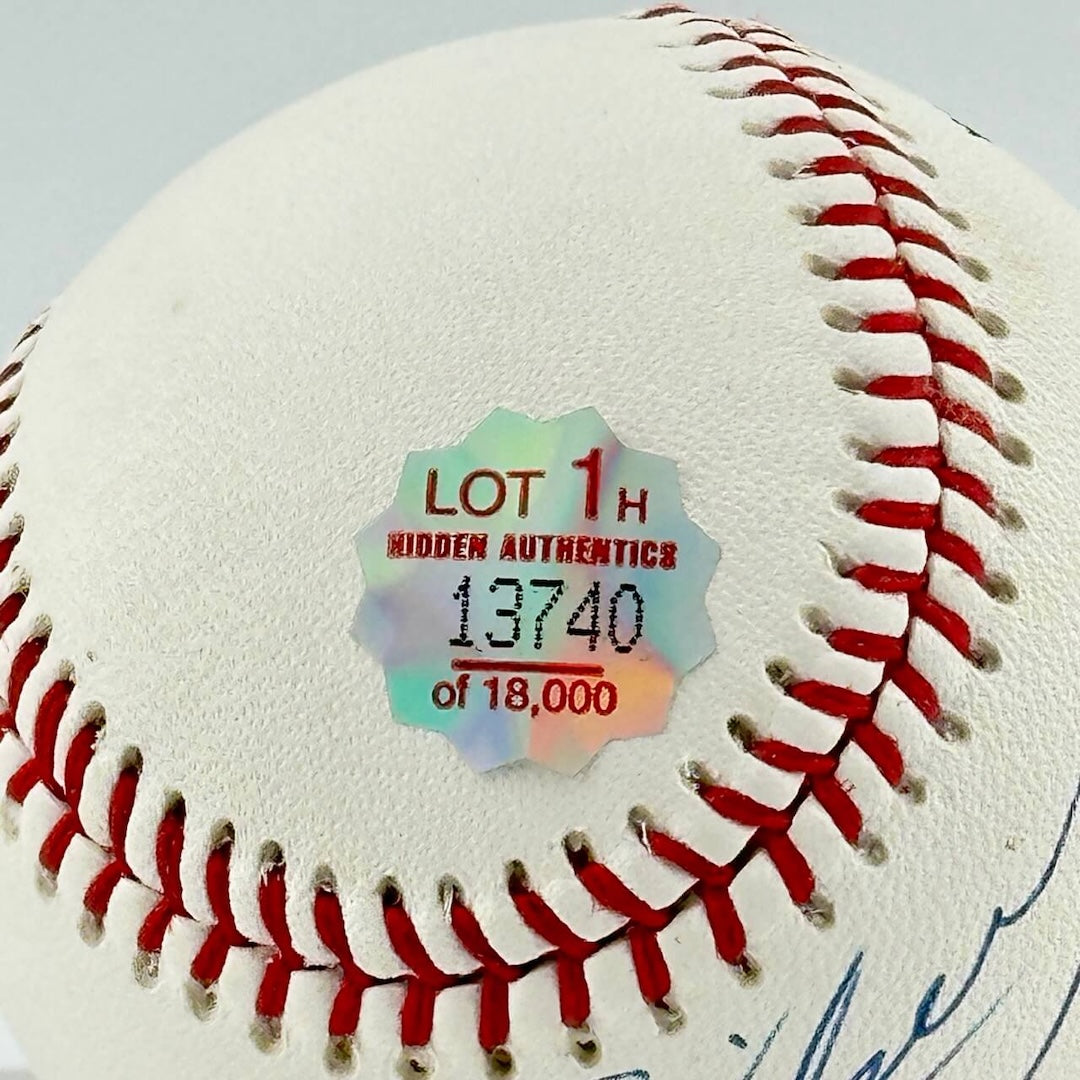Close up of Hidden Authentics sticker next to stitch line of ball, slightly above signature.