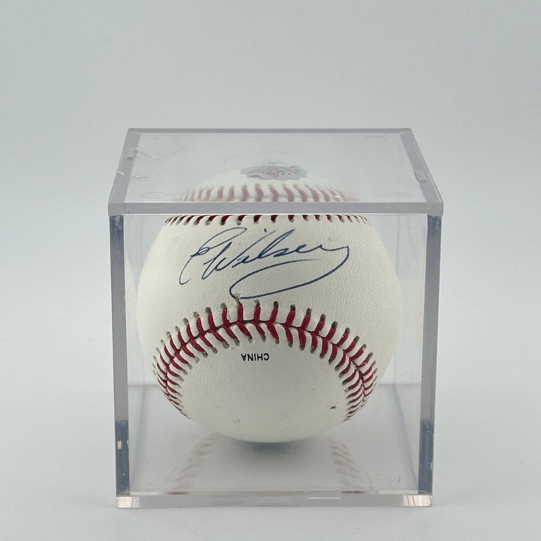 Autographed baseball in plastic cube, ball has two authentication stickers.