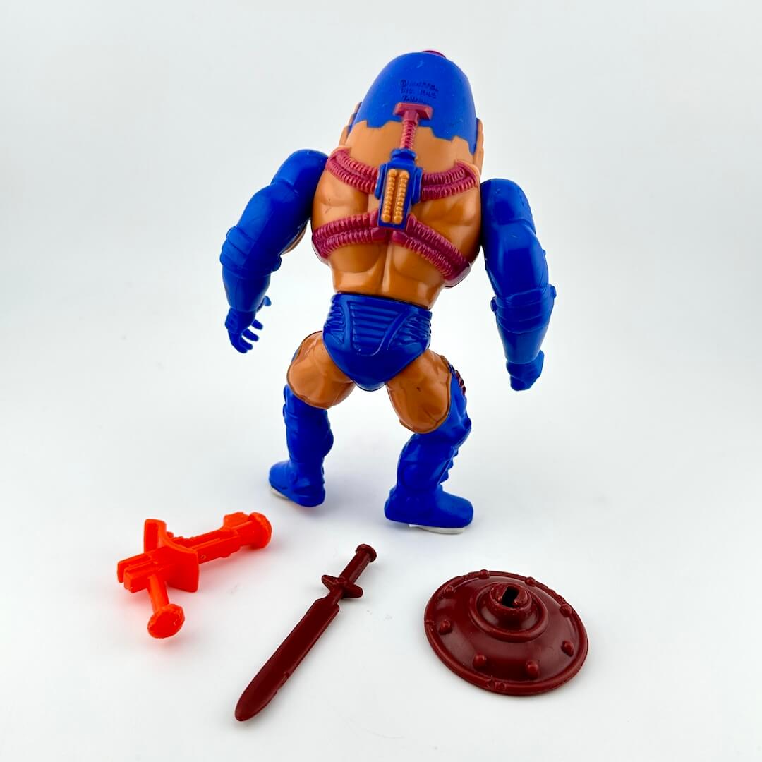 White male figure in blue armor pieces & helmet, with purple details & tubing. Pictured with three accessories.