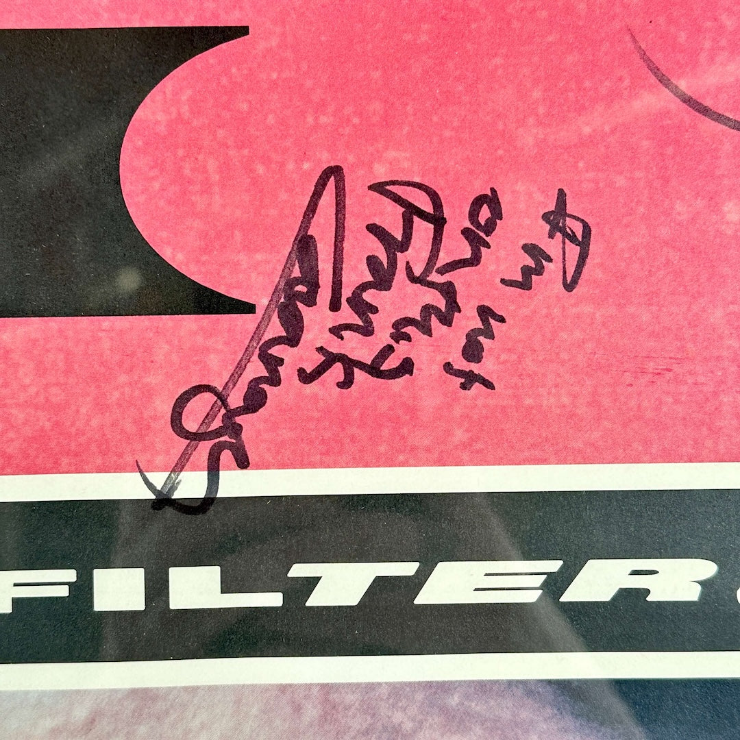 Close-up of a red and black poster packaging with 'FILTER' text and black signature.