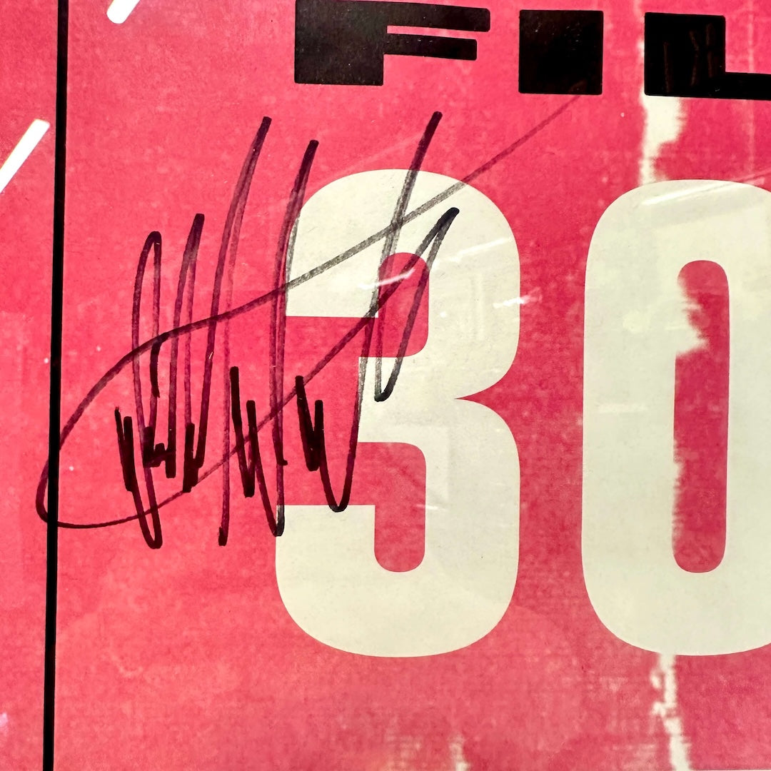 Close-up of a red and black poster packaging with 'FILTER' text and black signature.