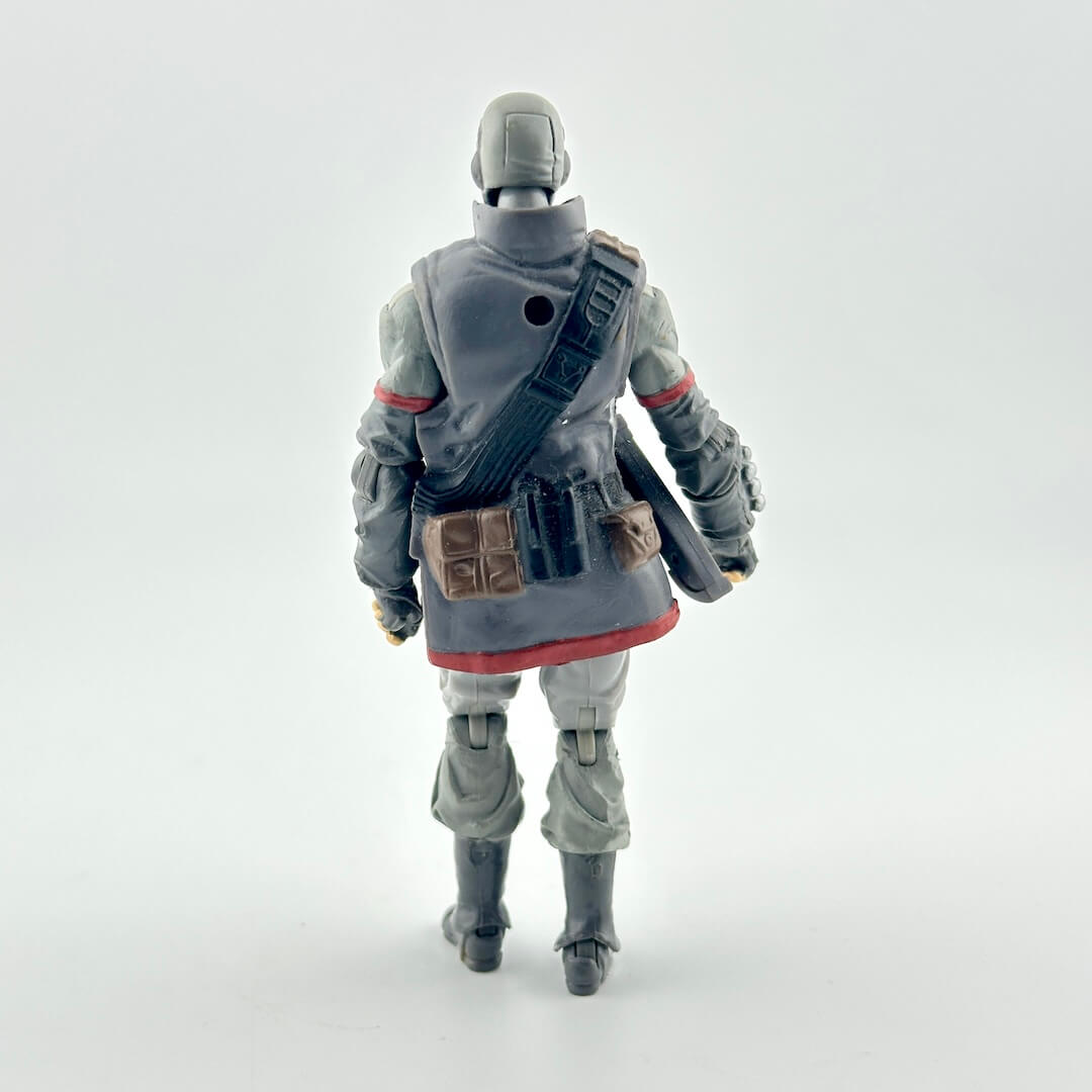 A toy action figure shown from the back, wearing a gray and white outfit with red accents and black boots.