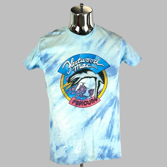 Front of blue tie dye short sleeved shirt with Fleetwood Mac Penguin circular logo printed in center.