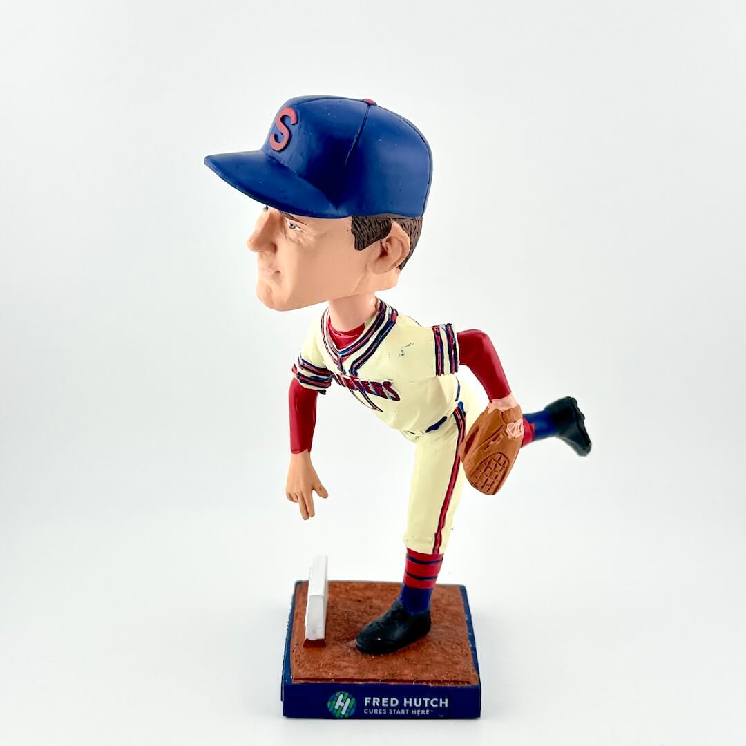 Bobblehead of a baseball player in a blue and red uniform with a glove, on a white background.