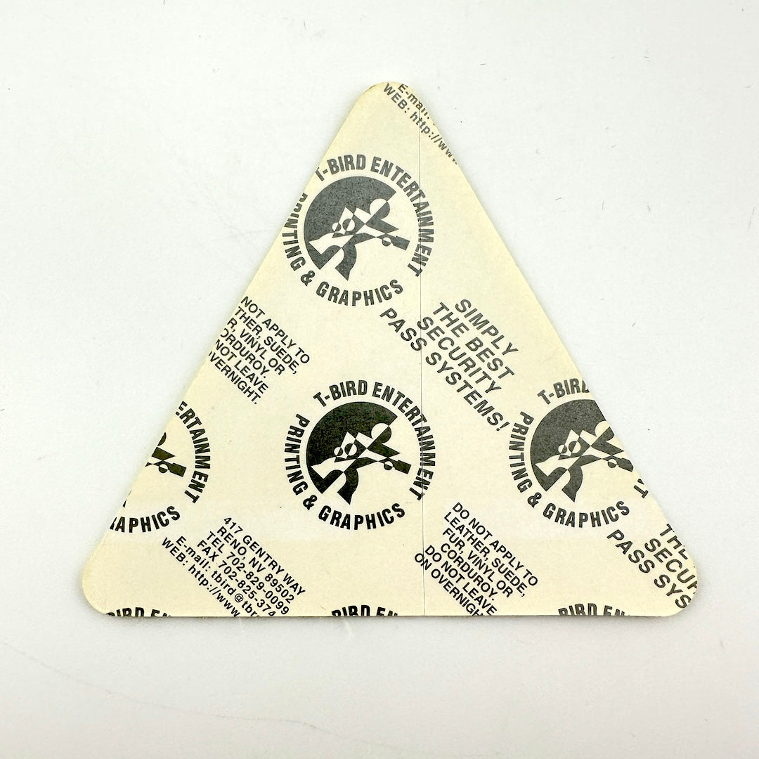 Backside of backstage pass showing intact paper backing.