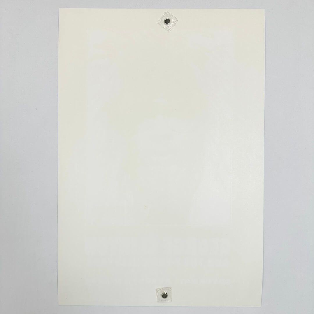 Backside of white poster showing zero damage against white background.
