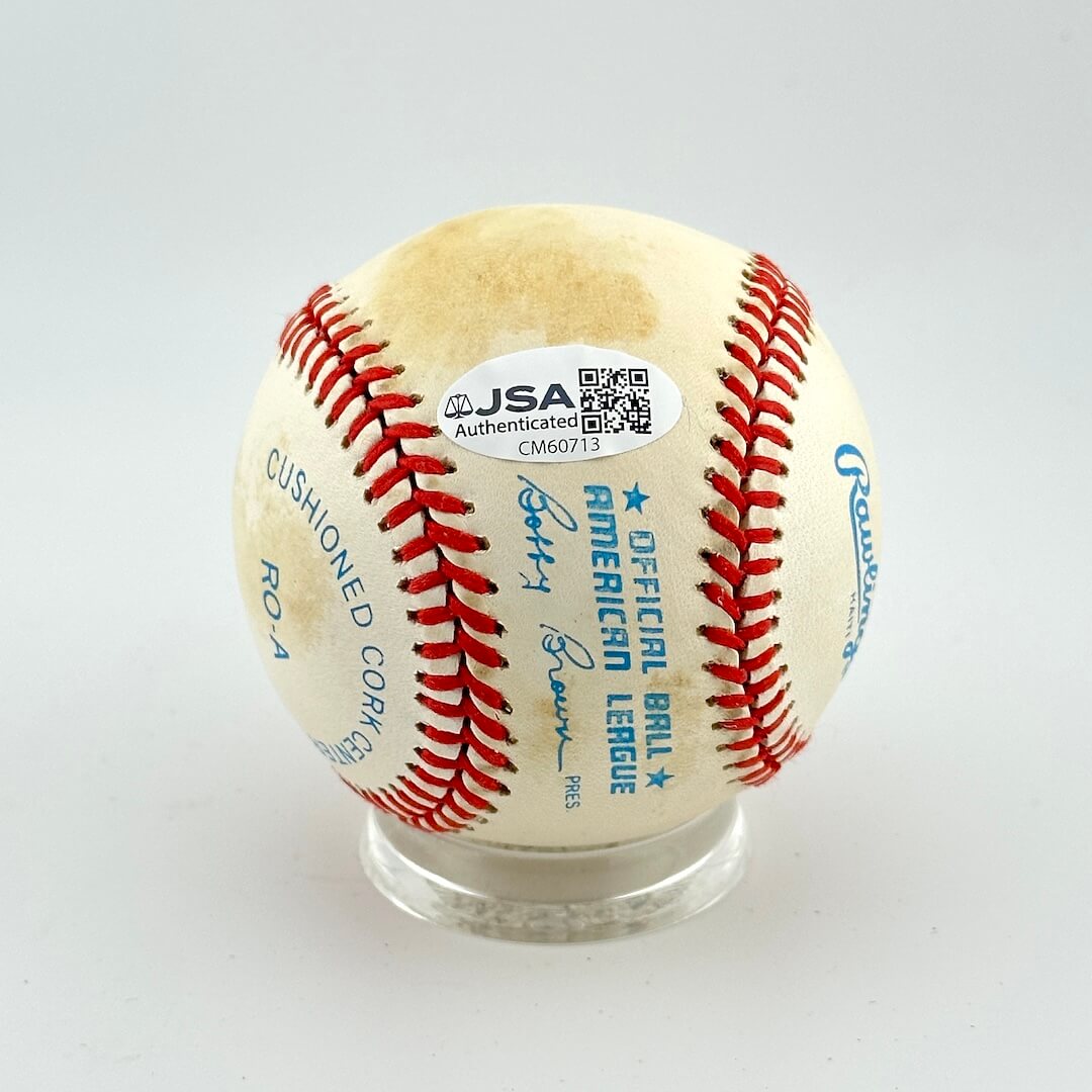 Baseball with JSA authentication label on a white background