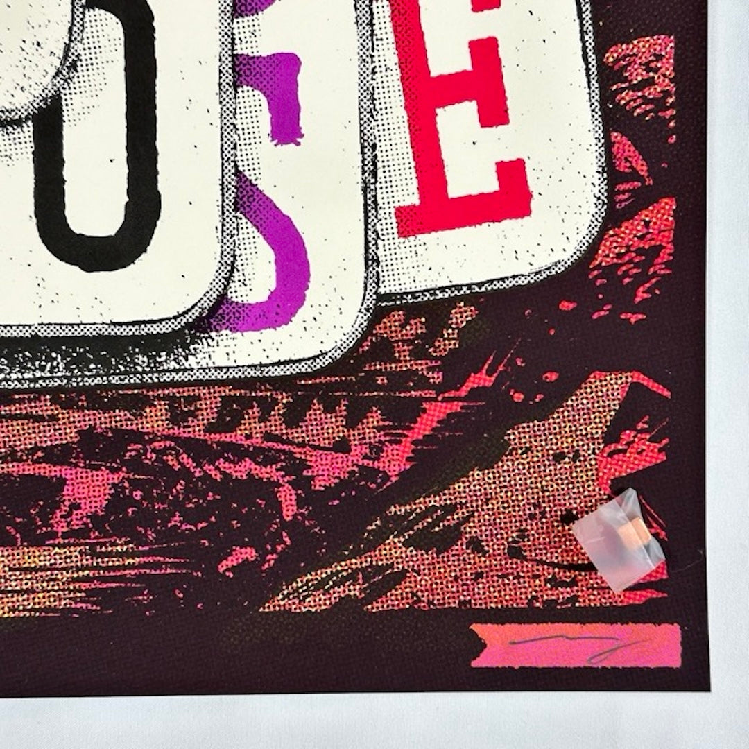 Bottom of white playing cards with letters OSE showing. Red rock background. Artist signature in lower right corner.
