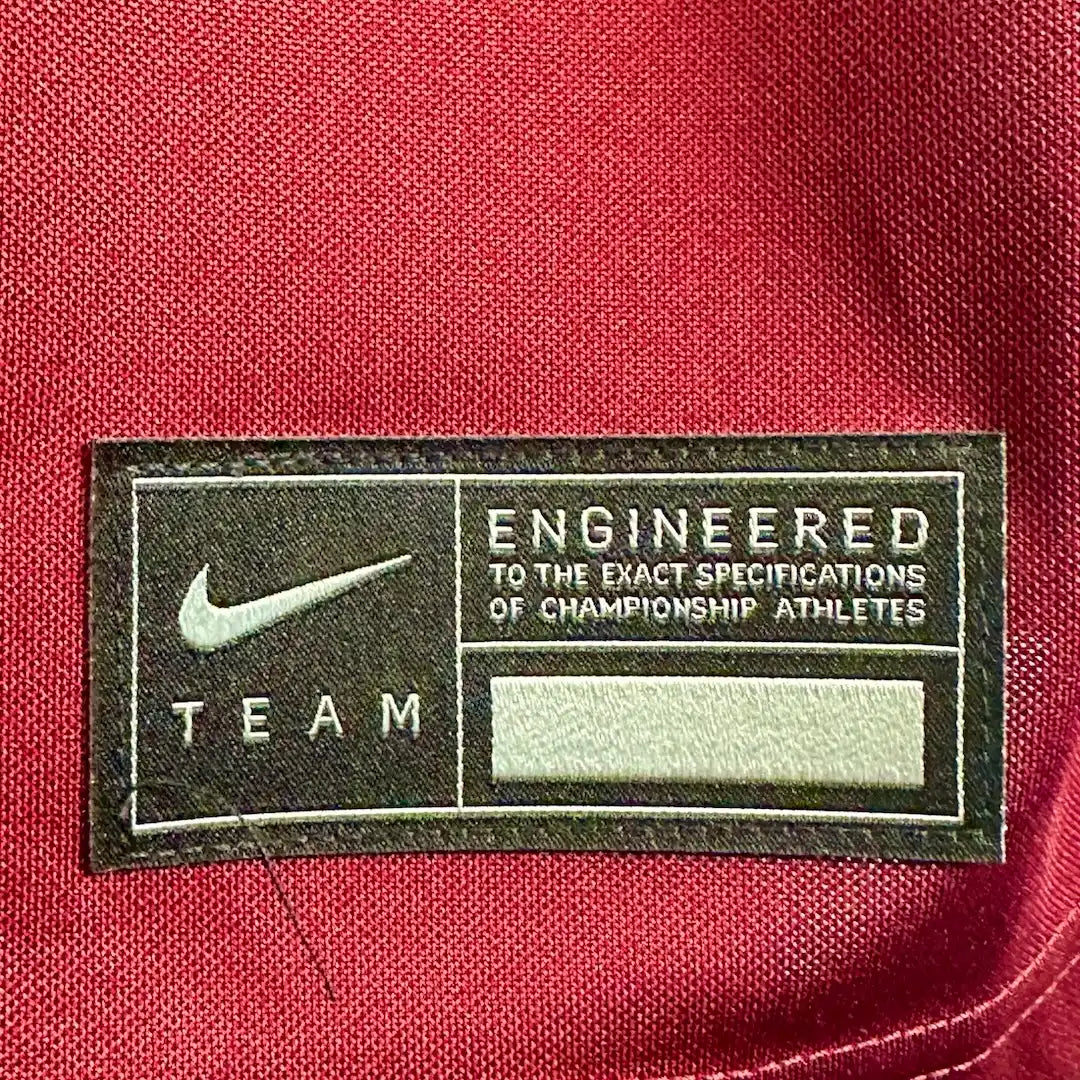 Close up of stitched hem tag on front with Nike information.