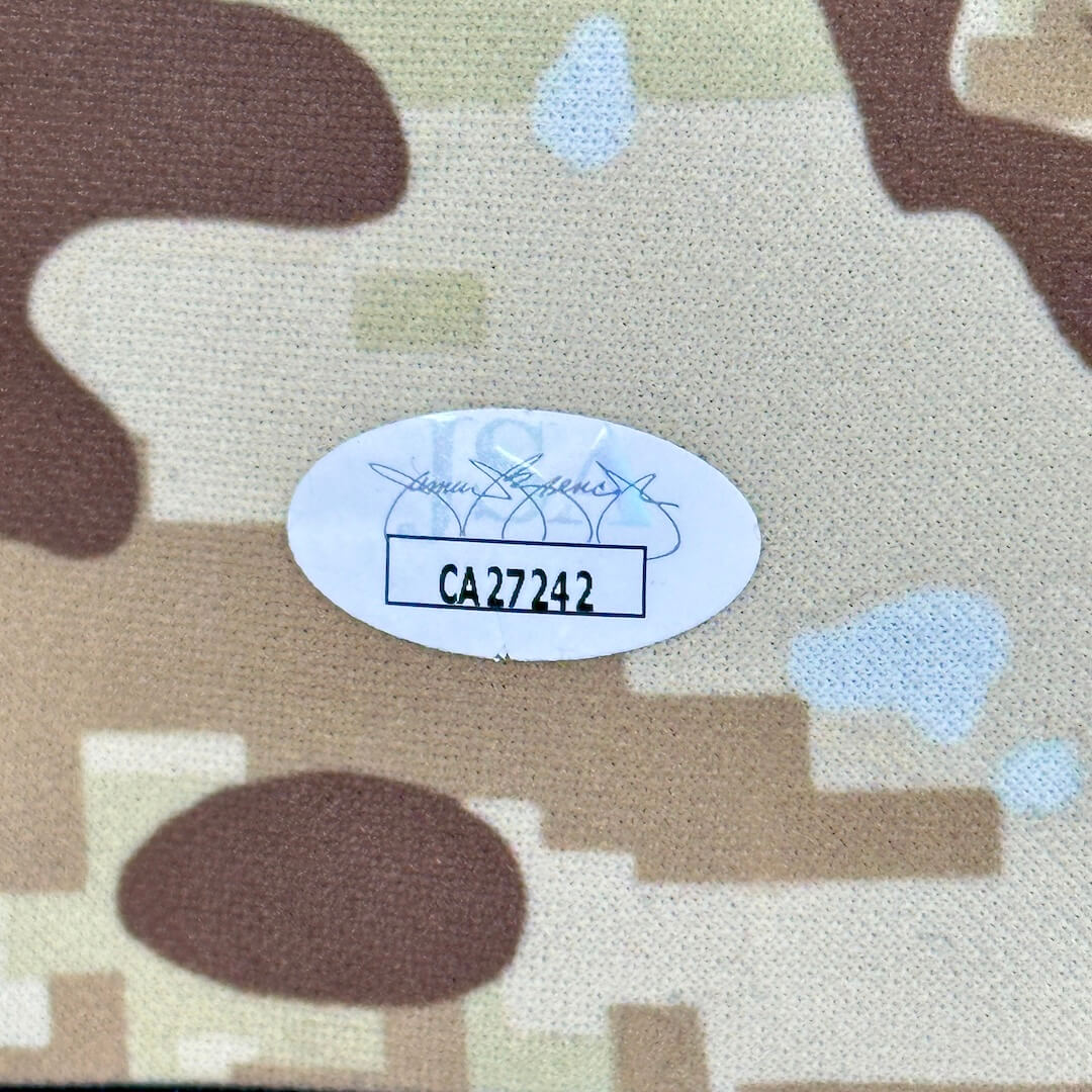 Camouflage fabric with a label and product number on a white background