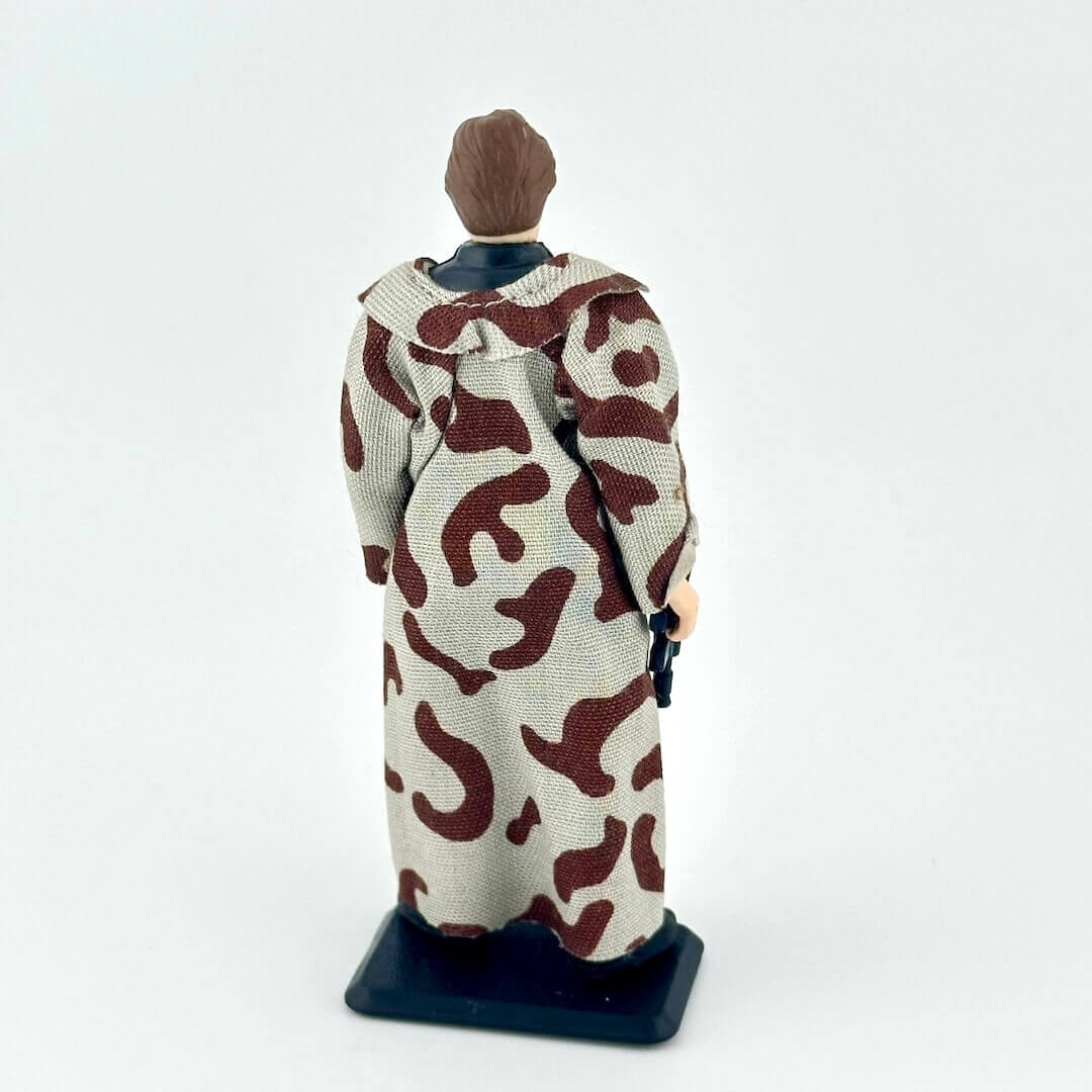 Figurine wrapped in a patterned cloth on a white background