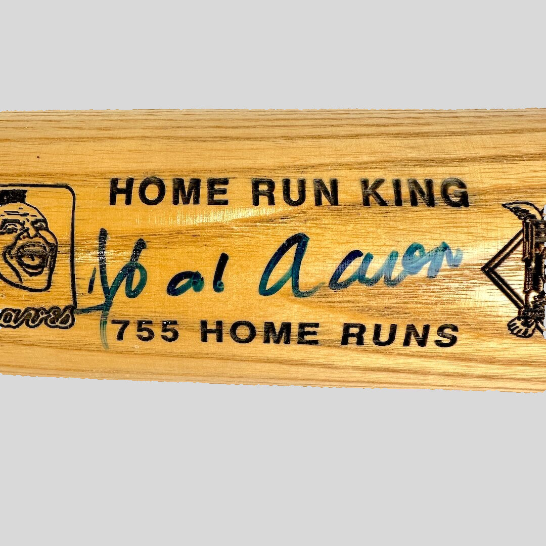 Wooden baseball bat with text and marker signature.