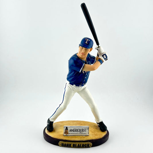 Baseball player figurine holding a bat on a white background