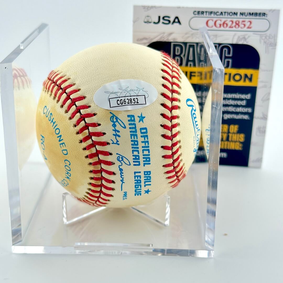 Signed baseball in clear display against white background with JSA certificate.