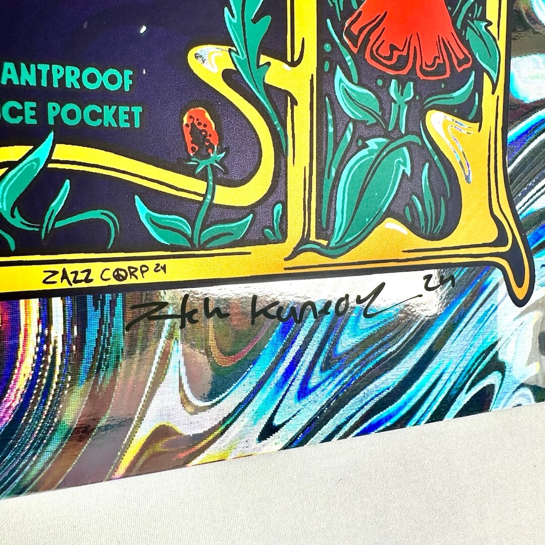 up-close of rainbow foil background. mushroom with leaves. hand written artist signature in black ink.