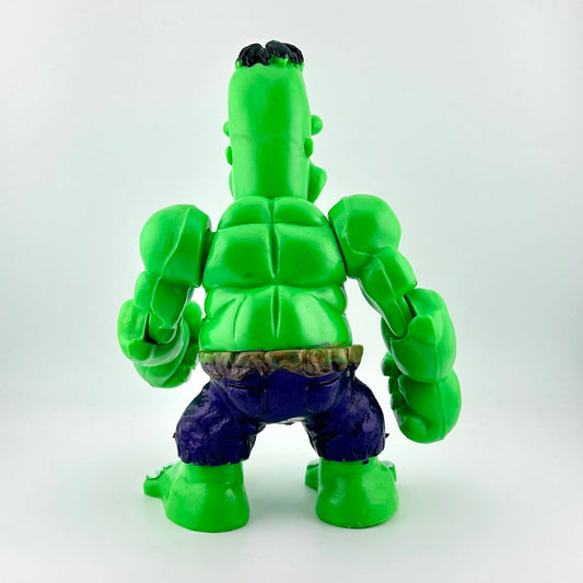 Green superhero action figure on a white background