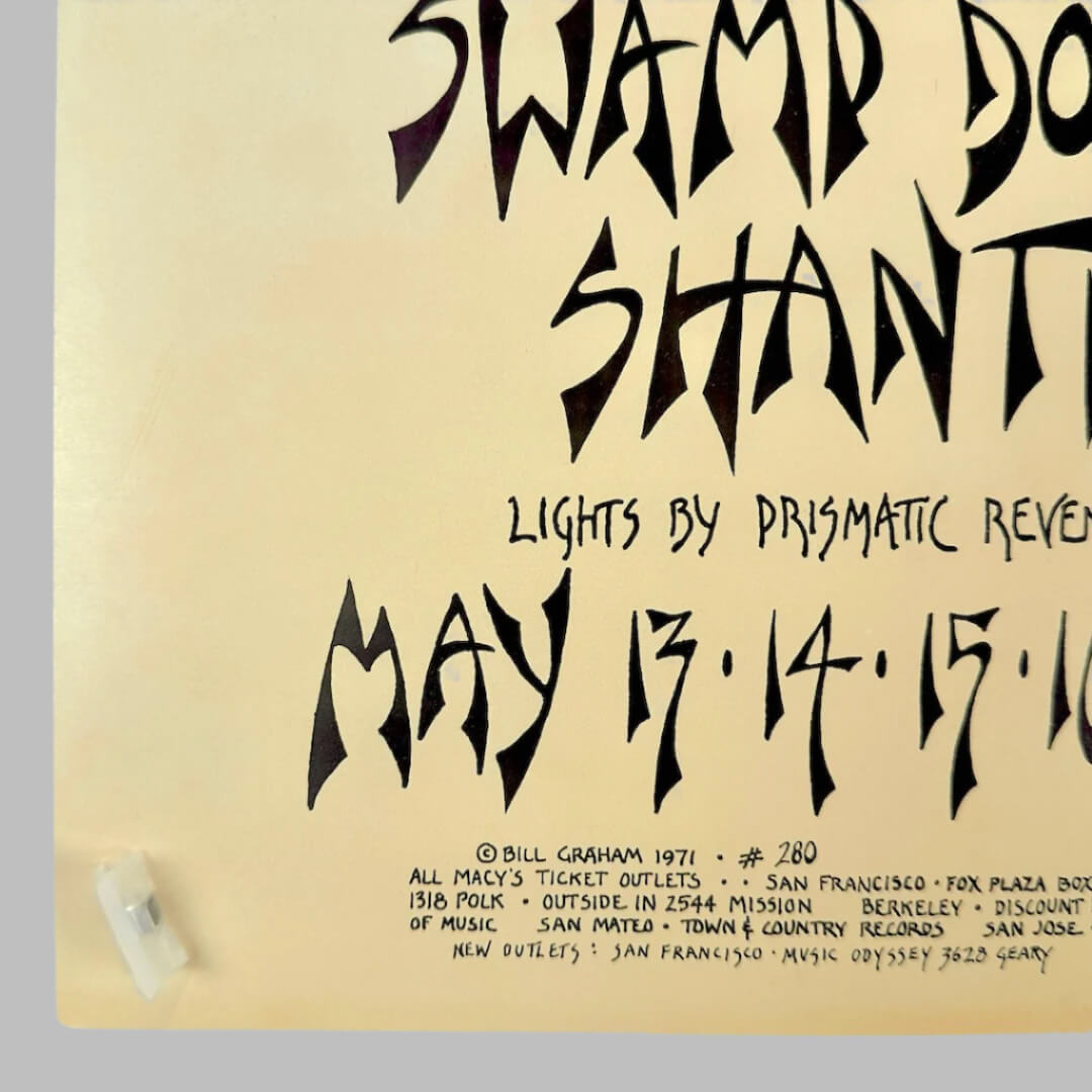 Bottom left corner showing slightly dulled corner. Copyright, ticketing, & event info seen in stylized black text.
