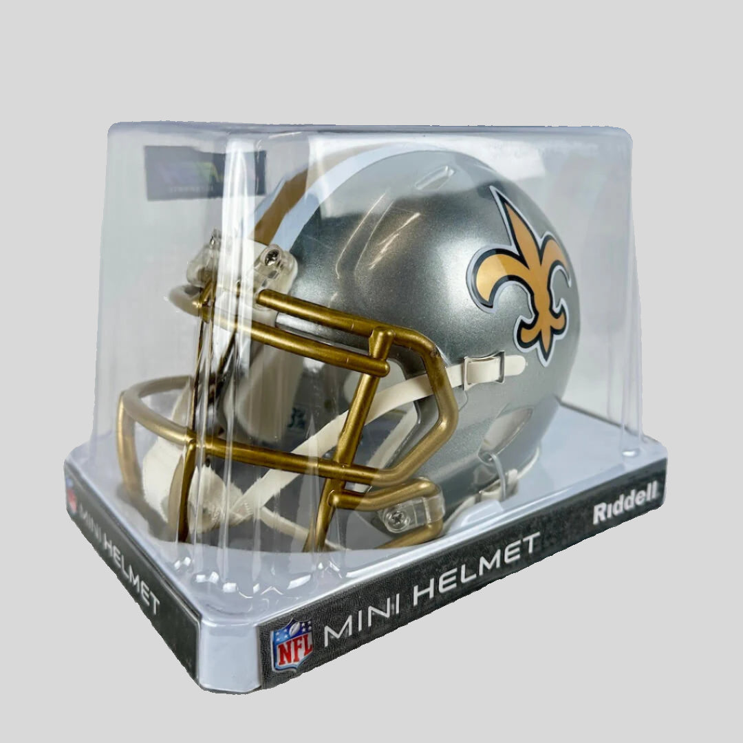 Saints mini helmet in plastic packaging on gray background.